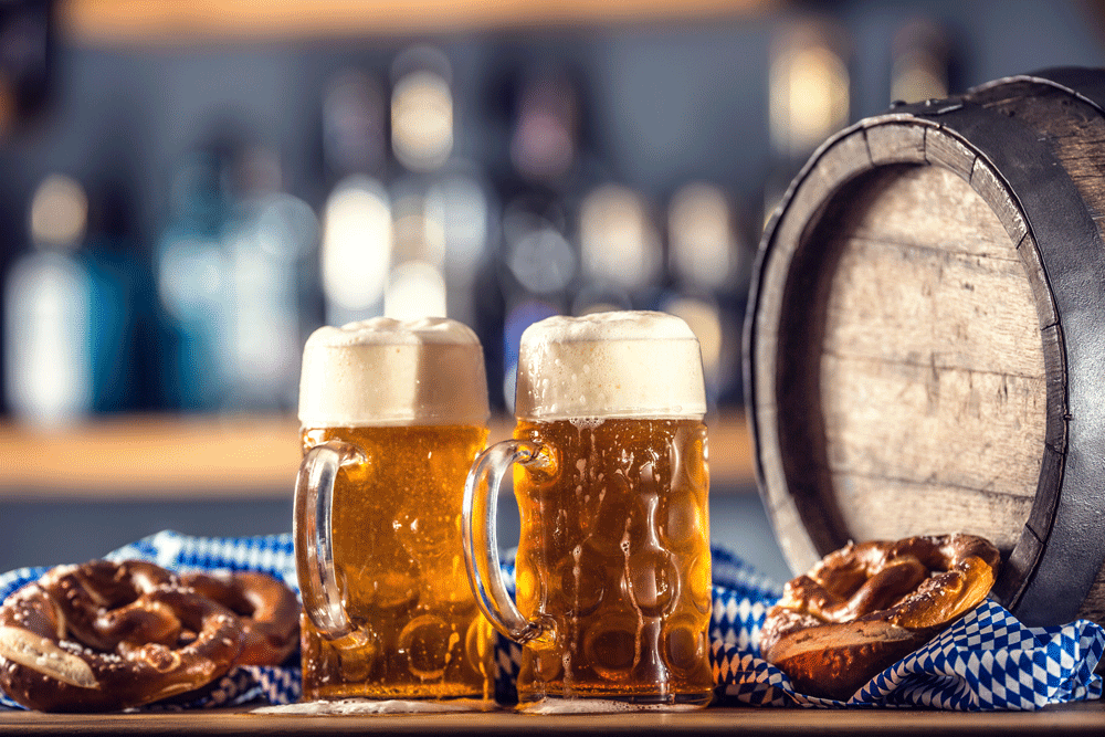 oktoberfest-two-large-beer-with-pretzel-wooden-barrel-blue-tablecloth