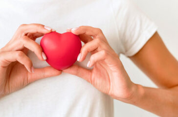 front-view-woman-holding-heart-shape