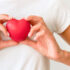 front-view-woman-holding-heart-shape