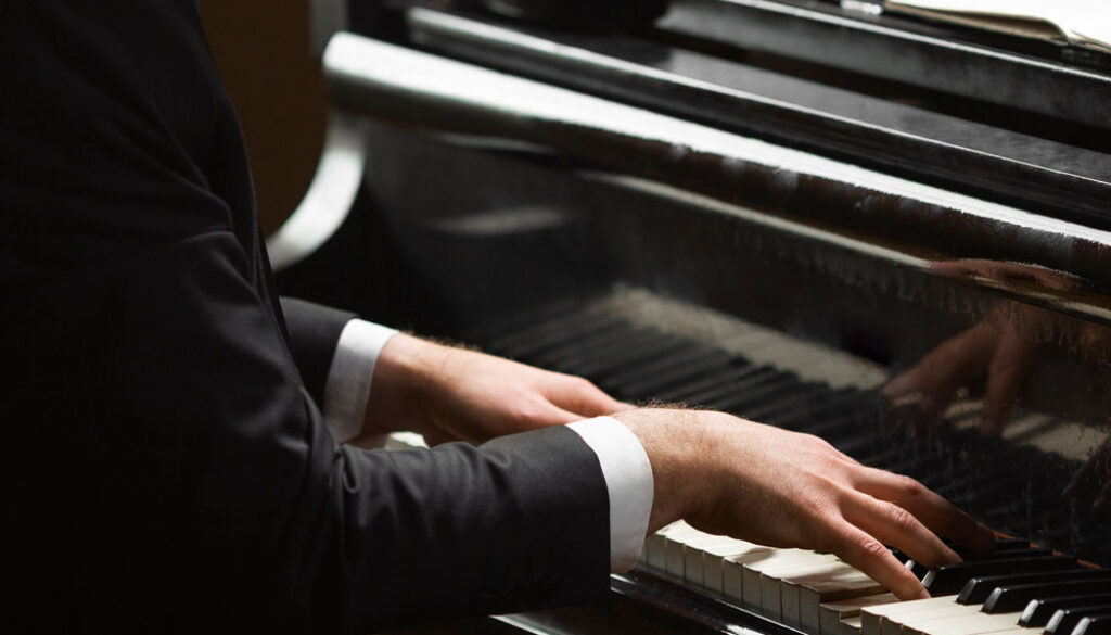 side-view-hands-playing-piano