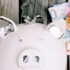 close-up-white-piggybank-s-face-with-euro-banknotes